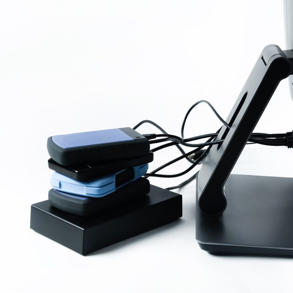 Multiple external hard drives connected to a monoblock on a white background.Computer with hard